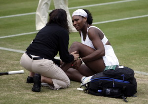 Tennis - Wimbledon - All England Lawn Tennis & Croquet Club, Wimbledon, England - 2/7/07 Serena Williams of the USA receives treatment to her calf as she suffers from cramp but plays on in the fourth round Mandatory Credit: Action Images / Reuters / Eddie Keogh Picture Supplied by Action Images *** Local Caption *** EK260_EK3022__Q2W0017.jpg