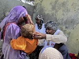 Mobile clinics in IDPs camp downtown Mogadishu close to former frontline. The team is screening for malnutrition. Dr Unni Karunakara examining a child.  MSF OCG started its emergency response to the Somali crisis of summer 2011 beginning of August. In addition to basic health care and nutritional care, the team launch a measles vaccination.