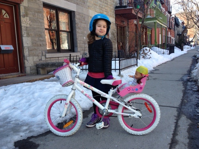 Both grandaughter and her doll are helmeted. 